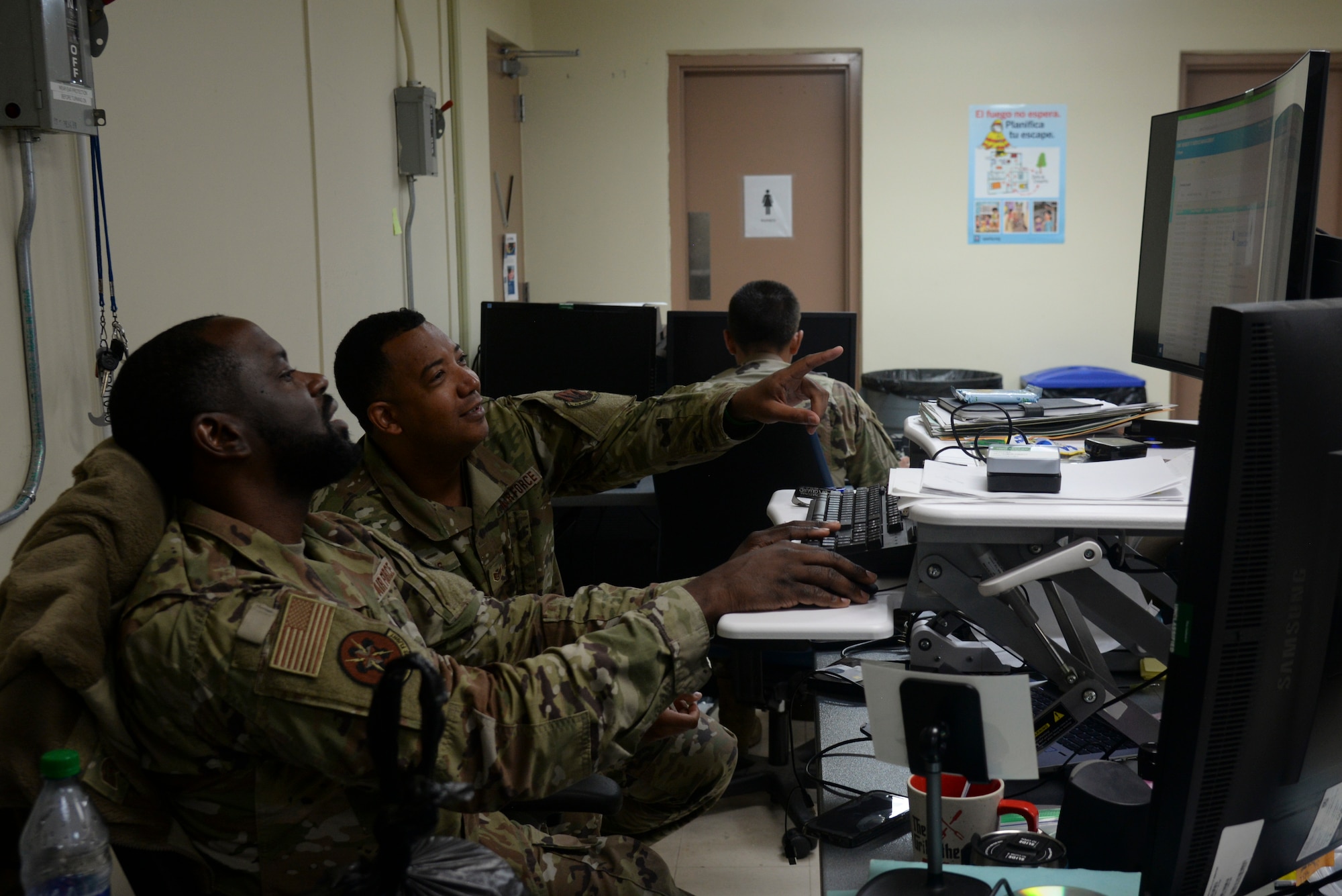Maryland Air National Guard Staff Sgt. Deonte West and Staff Sgt. Charles Gaskins, network operations specialists for the 175th Communications Squadron, review information on a computer at Muniz Air National Guard Base, Puerto Rico on July 24, 2023. The work was completed as part of annual training for the 175th Communications Squadron.