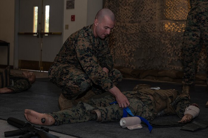U.S. Marine Corps Staff. Sgt Kyle Blankenship, a drill instructor with Kilo Company, 3rd Recruit Training Battalion, practices applying a tourniquet on a simulated casualty during a Tactical Combat Casualty Care training event at Marine Corps Recruit Depot San Diego, California, Jan. 31, 2024. TCCC teaches non-medical personnel the medical skills necessary to ensure lifesaving treatment can be rendered in the absence of a corpsman and improve the survivability of those wounded or injured in combat. (U.S. Marine Corps photo by Lance Cpl. Sarah M. Grawcock)