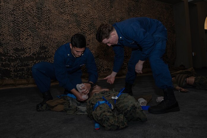 U.S. Coast Guardsman Petty Officer 3rd Class Dylan Lorenzen-Hrenko, metalsmith, right, and  Petty Officer 3rd Class Alex Tornabene, metalsmith, left, with Tactical Law Enforcement Team Pacific, practices Tactical Combat Casualty Care on a simulated casualty at Marine Corps Recruit Depot San Diego, California, Jan. 31, 2024. TCCC teaches non-medical personnel the medical skills necessary to ensure lifesaving treatment can be rendered in the absence of a corpsman and improve the survivability of those wounded or injured in combat. (U.S. Marine Corps photo by Lance Cpl. Sarah M. Grawcock)