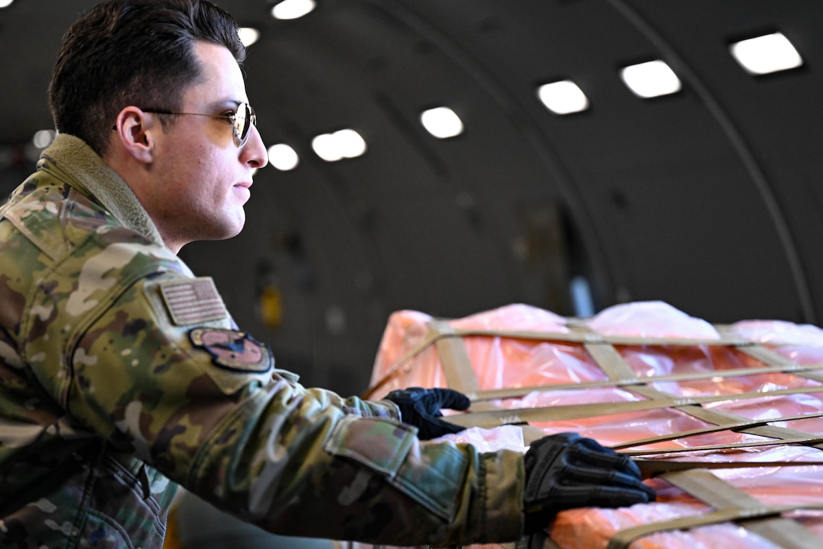 mans loads cargo onto an aircraft