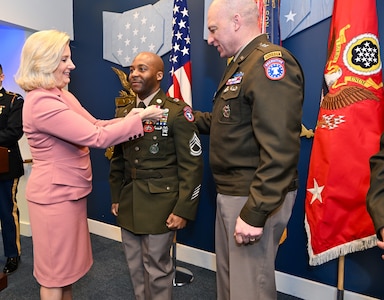 Hon. Christine Wormuth and Commanding General Johnny Davis pin USAREC Soldier during ceremony