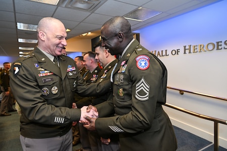 Commanding General Johnny Davis shakes hands with USAREC Soldier