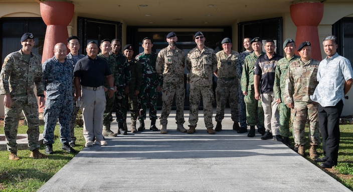 Leaders from U.S. Air Force, Japan Air Self Defense Force, Philippine Air Force, Indonesian Air Force, German Air Force, Royal Air Force, and Republic of Singapore Air Force gather for a group photo after a Security Forces Key Leader Engagement meeting during Pacific Defender at Andersen Air Force Base, Guam, Jan. 30, 2024. The purpose of the KLE meeting is to enhance interpersonal relationships among attendees, and provide networking opportunities for multilateral partnerships and allies. (U.S. Air Force photo by Airman 1st Class Audree Campbell)