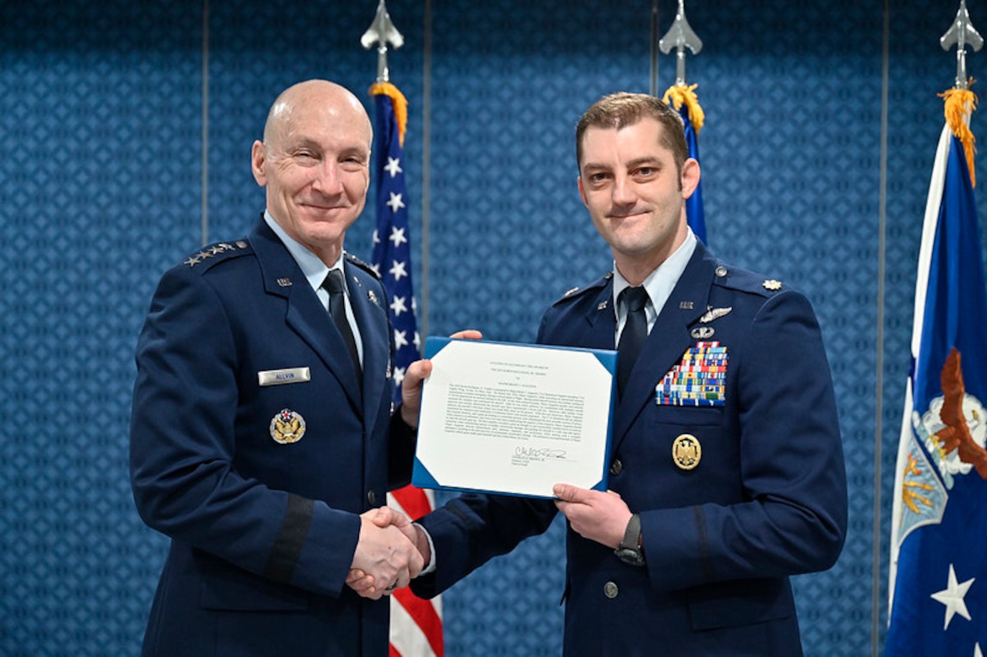 Air Force Chief of Staff Gen. David W. Allvin poses with Maj. Brady Augustin after presenting him the 2022 Koren Kolligian, Jr. Trophy during a ceremony at the Pentagon, Arlington, Va., Feb. 7, 2024.