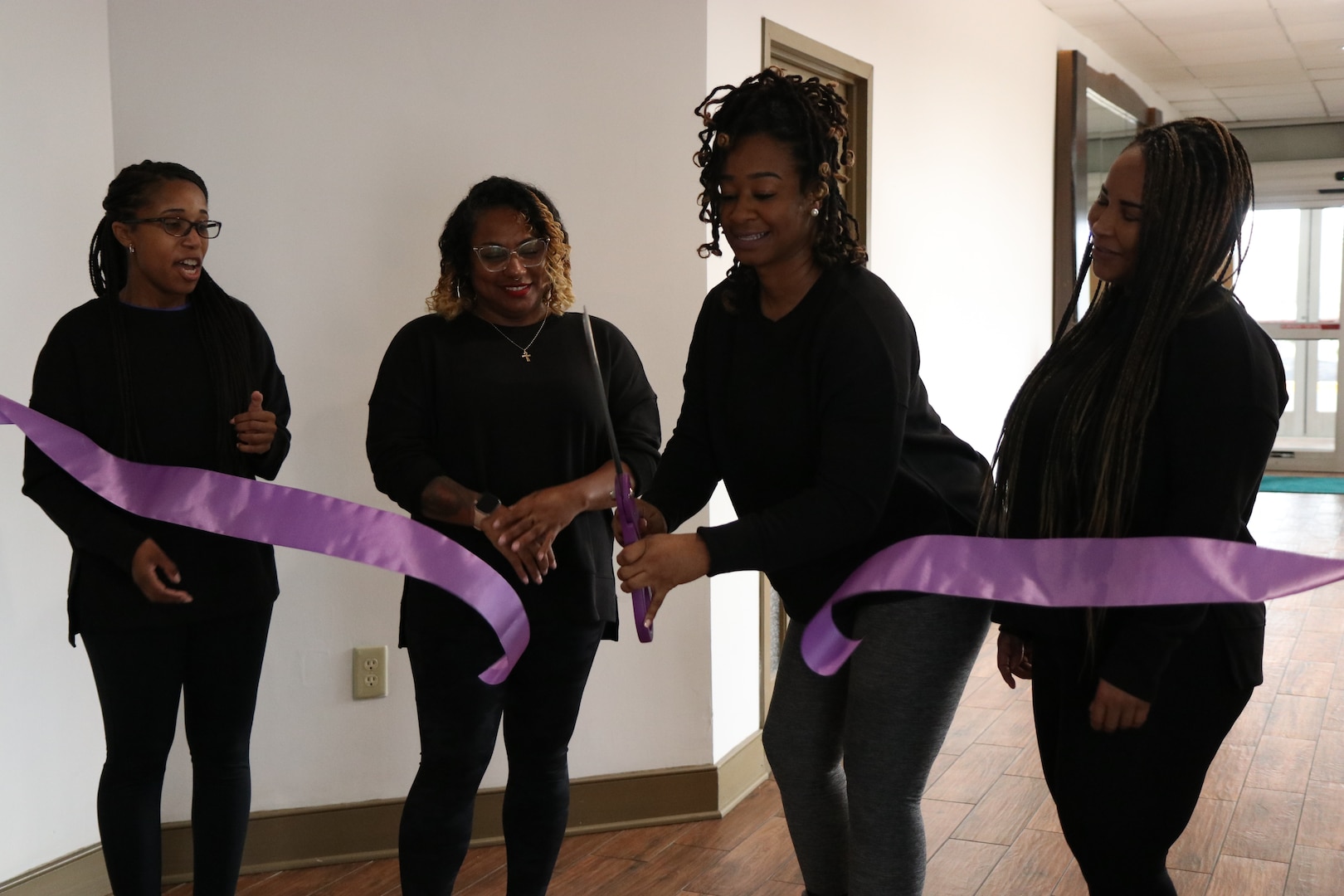 U.S. Army 1st Lt. Sherika Jenkins, Equal Opportunity Advisor with Joint Force Headquarters District of Columbia National Guard, cuts the ribbon signifying the launch of the District of Columbia National Guard’s Female Mentoring and Morale Program (FMMP) during the Family Programs Health and Wellness workshop at the Holiday Inn Alexandria-Carlyle, Alexandria, Va., Jan 27, 2024. The DCNG Female Mentoring and Morale Program is the second National Guard women's mentorship program chapter.