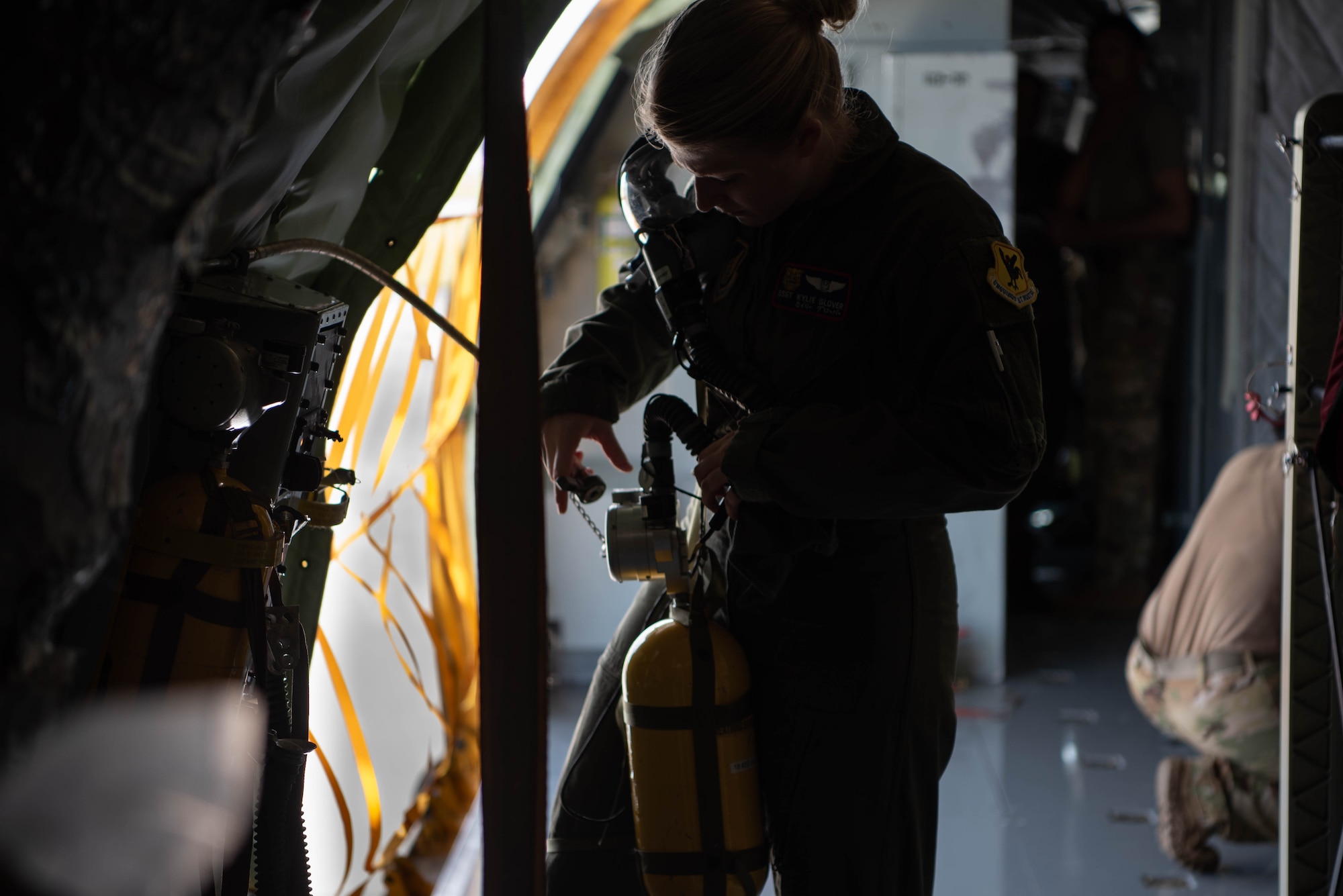 airmen holds oxygen tank