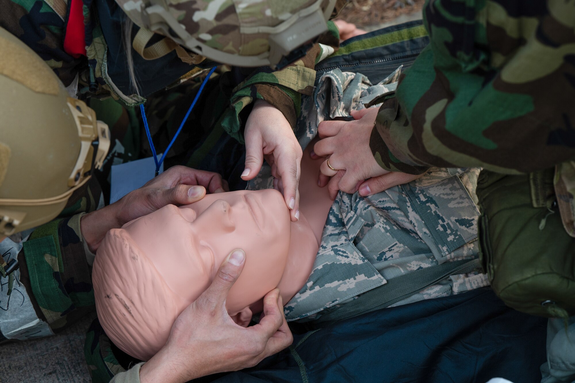 U.S. Air Force Airmen assigned to the 51st Fighter Wing simulate tactical combat casualty care on a medical training mannequin during Beverly Midnight 24-1 at Osan Air Base, Republic of Korea, Feb. 1, 2024. Airmen were tested during BM24-1 to perform basic life-saving techniques known as TCCC to stabilize trauma patients until medical personnel arrive.  BM24-1 is a routine training event that tests the military capabilities across the peninsula, allowing combined and joint training at both the operational and tactical levels. (U.S. Air Force photo by Senior Airman Brittany Russell)