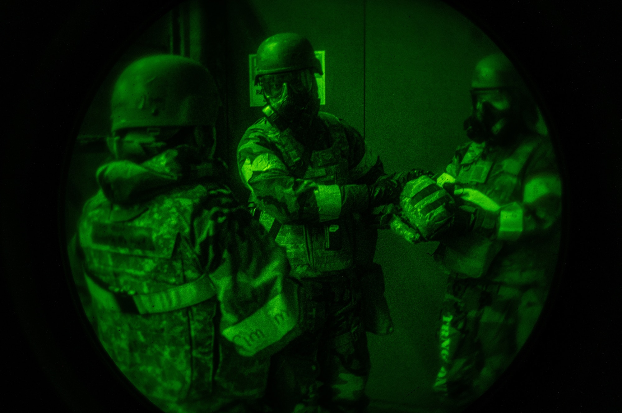 From the left, U.S. Air Force Senior Airman Izeyah Minix, 51st Force Support Squadron food service journeyman, Airman 1st Class Joseph Schaefer and Devin Dewall, 51st FSS storeroom clerk service journeymen, gather equipment for a post attack reconnaissance sweep following a simulated attack during Beverly Midnight 24-1 at Osan Air Base, Republic of Korea, Jan. 30, 2024. Airmen are trained to decontaminate each other following exposure to potential contaminants. The 51st Fighter Wing guards the freedom of 51 million people by deterring aggression, defending the ROK, and defeating any attack against the ironclad ROK-US Alliance. (U.S. Air Force photo by Airman 1st Class Chase Verzaal)