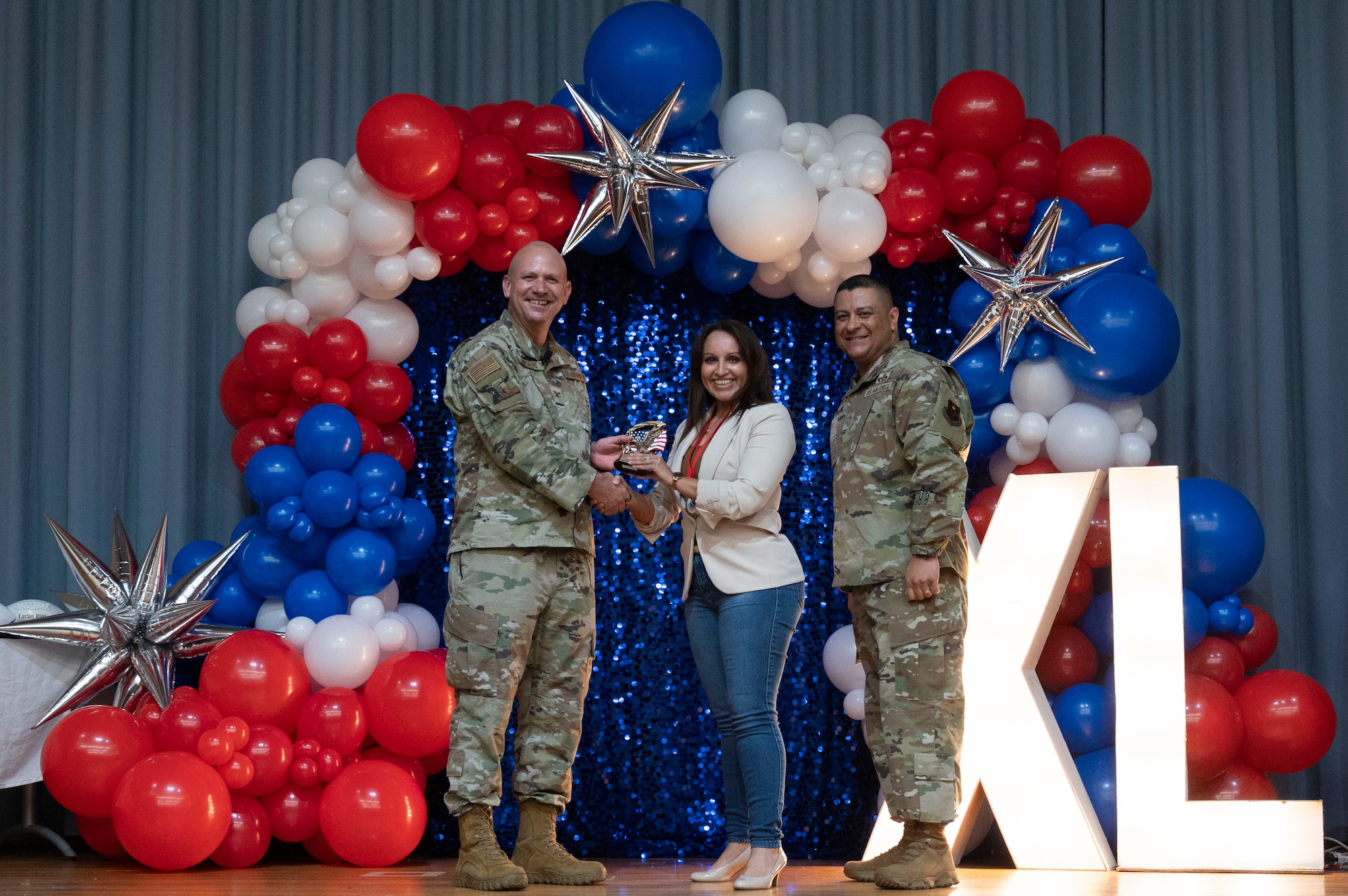 U.S. Air Force Col. Kevin Davidson, 47th Flying Training Wing (FTW) commander, and Chief Master Sgt. Lester Largaespada, 47th FTW command chief, present Karla Hernandez, 47th Mission Support Group, an award during the 2023 47th FTW Annual Awards Ceremony at Laughlin Air Force Base, Texas, Feb. 2, 2024. Annual award winners were selected based on their technical expertise, demonstration of leadership and job performance. (U.S. Air Force photo by Senior Airman Kailee Reynolds)
