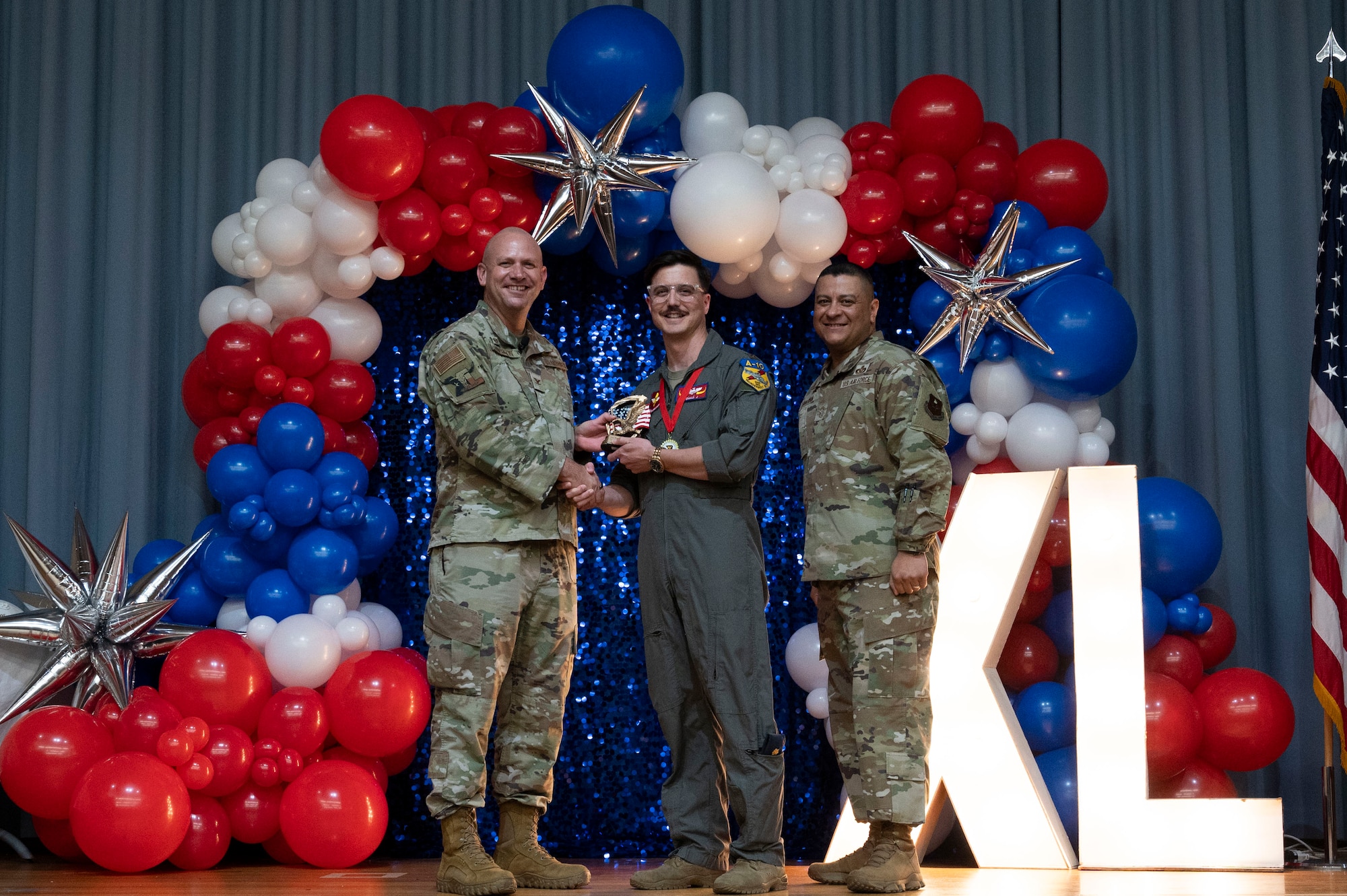 U.S. Air Force Col. Kevin Davidson, 47th Flying Training Wing (FTW) commander, and Chief Master Sgt. Lester Largaespada, 47th FTW command chief, present Maj. Stephen Crump, 47th Operations Group, an award during the 2023 47th FTW Annual Awards Ceremony at Laughlin Air Force Base, Texas, Feb. 2, 2024. These awards recognized the top performers throughout the 47th Flying Training Wing during fiscal year 2023. (U.S. Air Force photo by Senior Airman Kailee Reynolds)