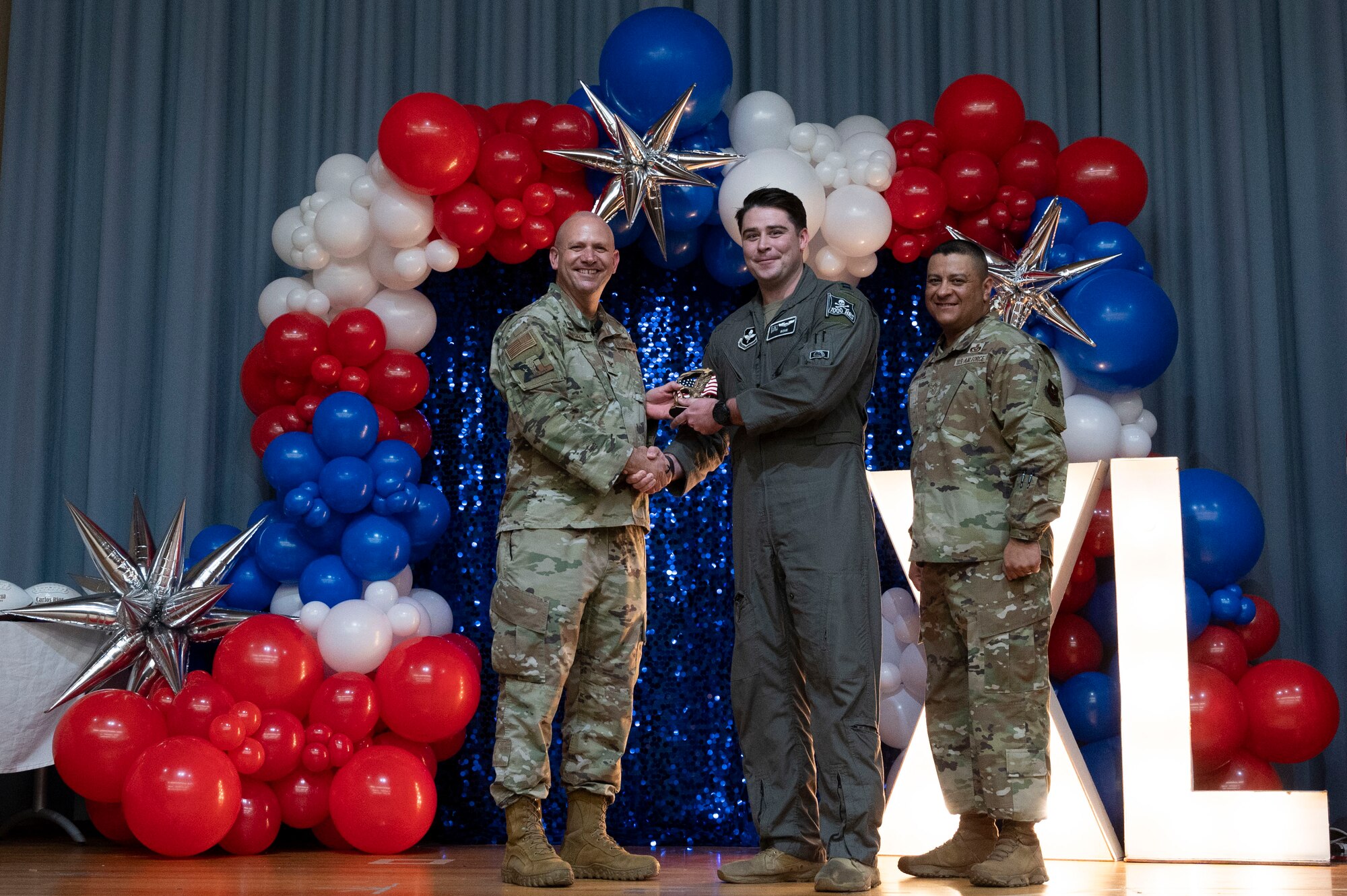 U.S. Air Force Col. Kevin Davidson, 47th Flying Training Wing (FTW) commander, and Chief Master Sgt. Lester Largaespada, 47th FTW command chief, present Capt. Patrick Clancy, 85th Flying Training Squadron, an award during the 2023 47th FTW Annual Awards Ceremony at Laughlin Air Force Base, Texas, Feb. 2, 2024. The annual awards recognized the top performers throughout the 47th Flying Training Wing during fiscal year 2023. (U.S. Air Force photo by Senior Airman Kailee Reynolds)