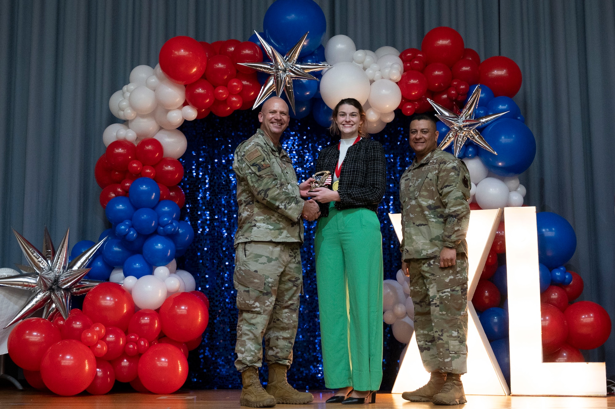 U.S. Air Force Col. Kevin Davidson, 47th Flying Training Wing (FTW) commander, and Chief Master Sgt. Lester Largaespada, 47th FTW command chief, present Catherine Stephens, 434th Flying Training Squadron key spouse, an award during the 2023 47th FTW Annual Awards Ceremony at Laughlin Air Force Base, Texas, Feb. 2, 2024. The annual awards recognized the top performers throughout the 47th Flying Training Wing during fiscal year 2023. (U.S. Air Force photo by Senior Airman Kailee Reynolds)