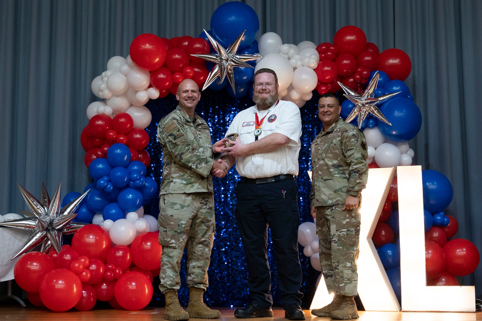 U.S. Air Force Col. Kevin Davidson, 47th Flying Training Wing (FTW) commander, and Chief Master Sgt. Lester Largaespada, 47th FTW command chief, present David Mercer, 47th Maintenance Directorate, an award during the 2023 47th FTW Annual Awards Ceremony at Laughlin Air Force Base, Texas, Feb. 2, 2024. The annual awards recognized the top performers throughout the 47th Flying Training Wing during fiscal year 2023. (U.S. Air Force photo by Senior Airman Kailee Reynolds)