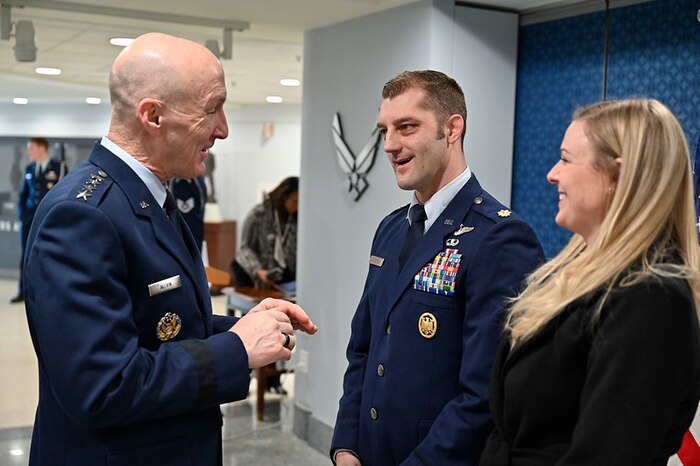 Air Force Chief of Staff Gen. David W. Allvin speaks with Maj. Brady Augustin and Adelaide Augustin after he was awarded the 2022 Koren Kolligian, Jr. Trophy during a ceremony at the Pentagon, Arlington, Va., Feb. 7, 2024.