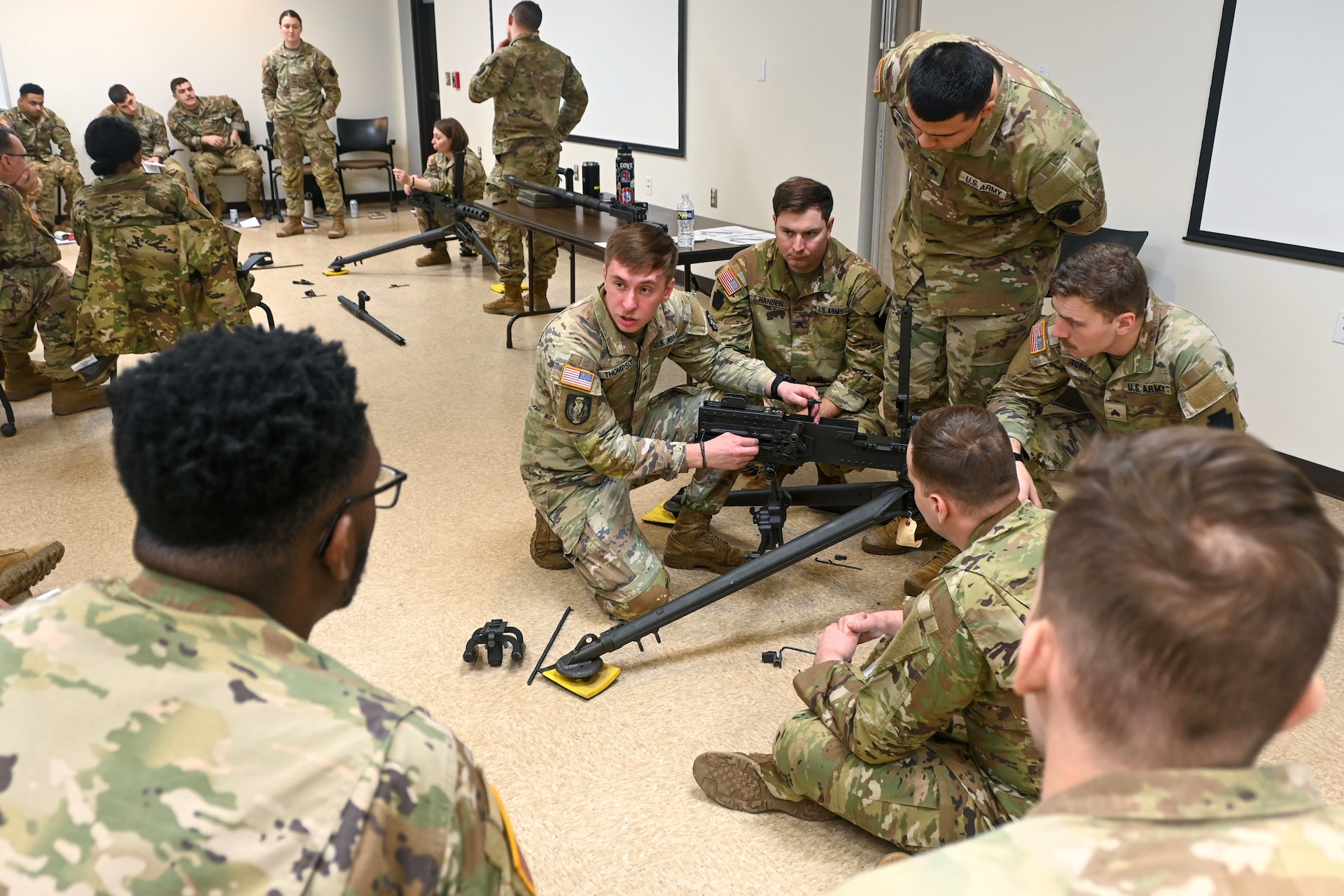 U.S. Soldiers with the Pennsylvania National Guard engage in hands-on learning in the classroom portion the crew served weapons course at Fort Indiantown Gap, Pennsylvania, Jan. 26, 2024. The crew served weapons course is offered through the Pennsylvania National Guard's Individual Training Branch. 28 students from units across the state honed their marksmanship skills by training on the M249 light machine gun, M240B machine gun, Mark 19 40 mm grenade machine gun and M2A1 machine gun to become subject matter experts on those weapon systems. (U.S. Army National Guard photo by Sgt. 1st Class Zane Craig)