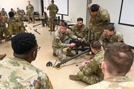 U.S. Soldiers with the Pennsylvania National Guard engage in hands-on learning in the classroom portion the crew served weapons course at Fort Indiantown Gap, Pennsylvania, Jan. 26, 2024. The crew served weapons course is offered through the Pennsylvania National Guard's Individual Training Branch. 28 students from units across the state honed their marksmanship skills by training on the M249 light machine gun, M240B machine gun, Mark 19 40 mm grenade machine gun and M2A1 machine gun to become subject matter experts on those weapon systems. (U.S. Army National Guard photo by Sgt. 1st Class Zane Craig)