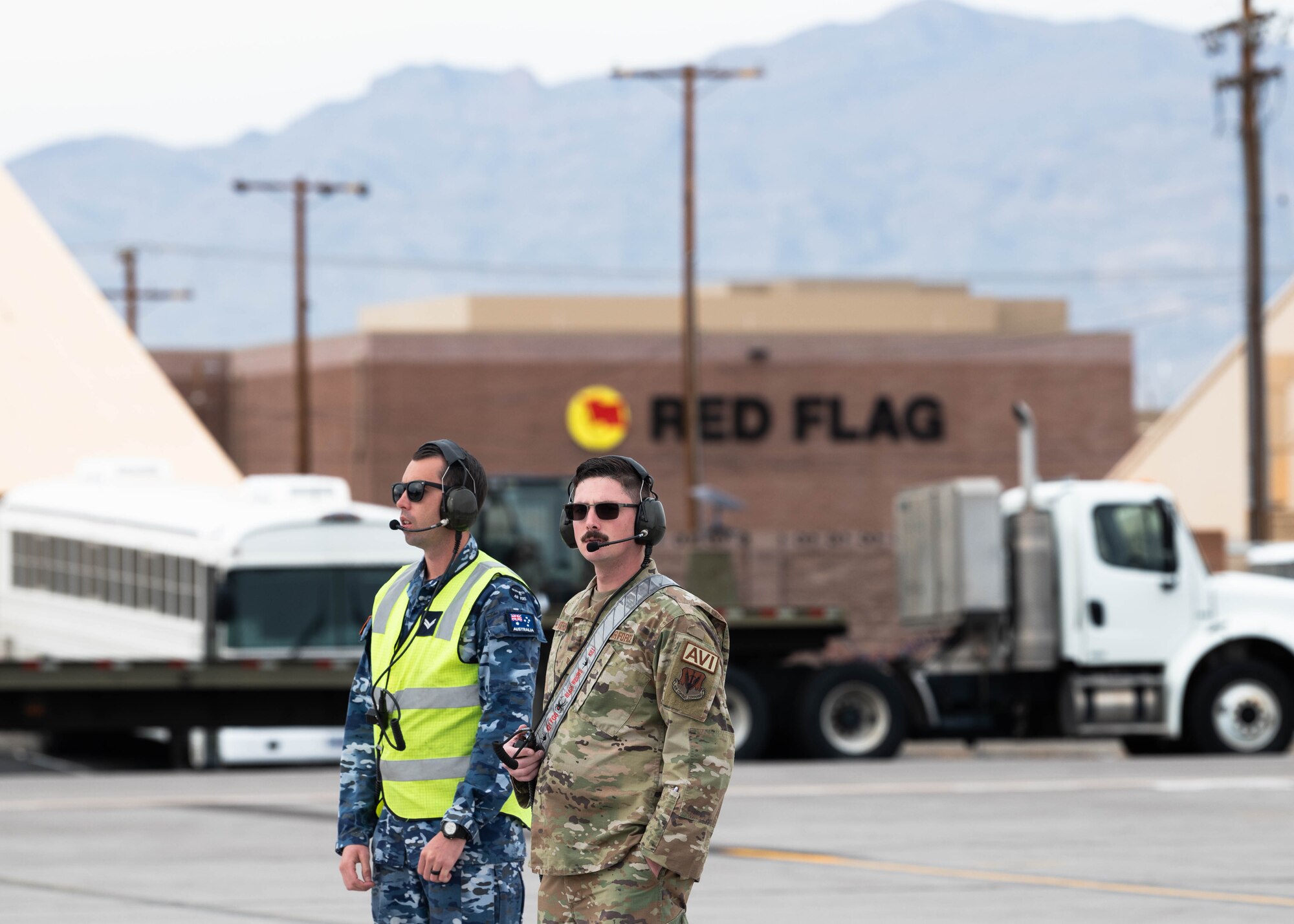 A photo of maintenance personnel standing on the flightline