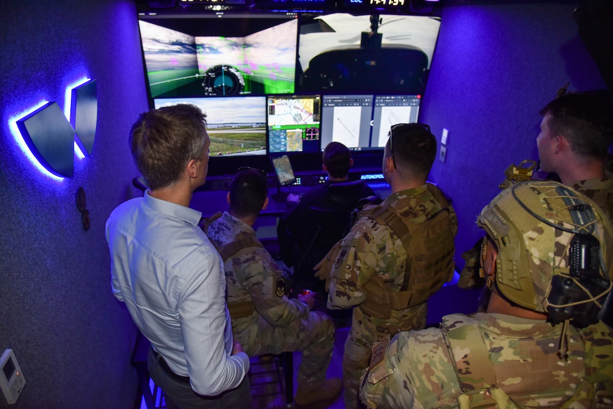Maxime Gariel, left, Xwing co-founder and chief technology officer, briefs Airmen about their autonomous flight capabilities in the Xwing ground control station during AGILE FLAG 24-1 at McClellan Airfield in Sacramento, Calif., Jan. 30, 2024.