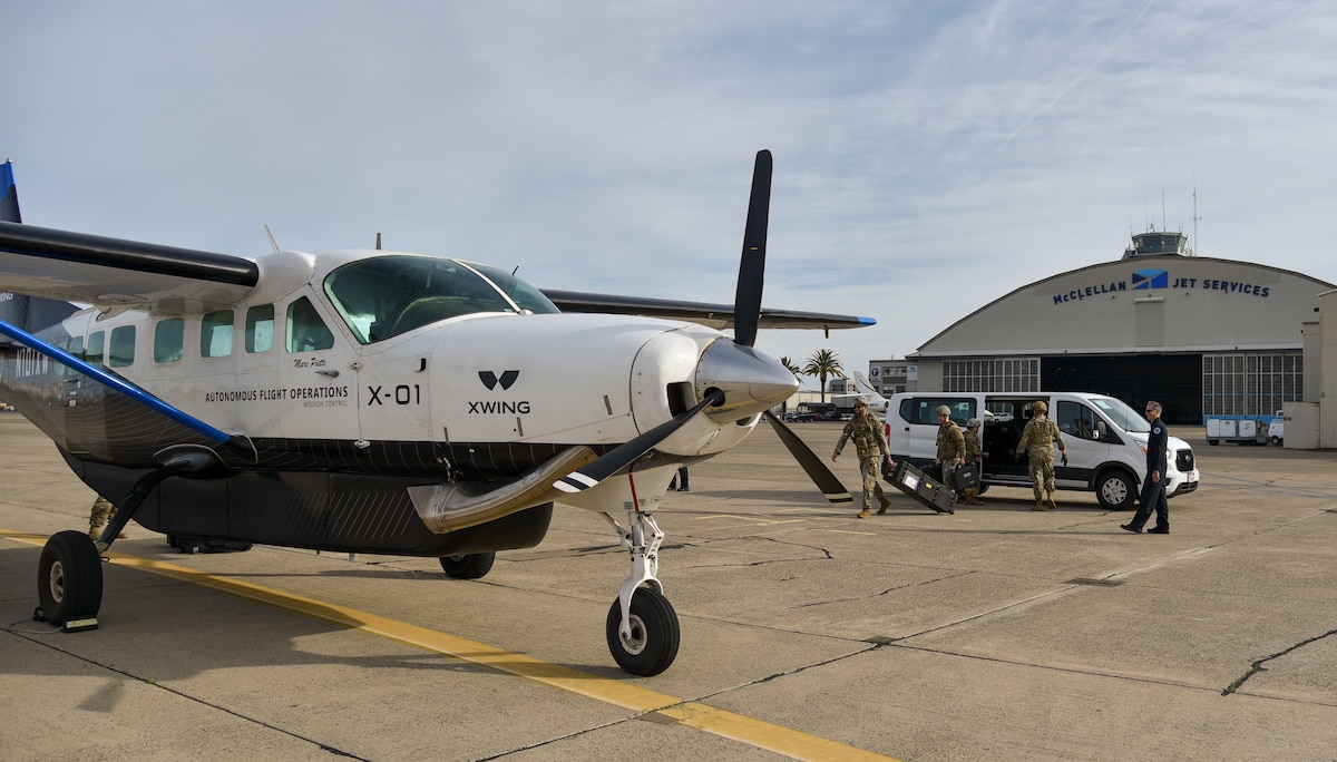 Airmen load weather equipment into Xwing's autonomous Cessna 208B Grand Caravan during AGILE FLAG 24-1 at McClellan Airfield in Sacramento, California, Jan. 27, 2024.
