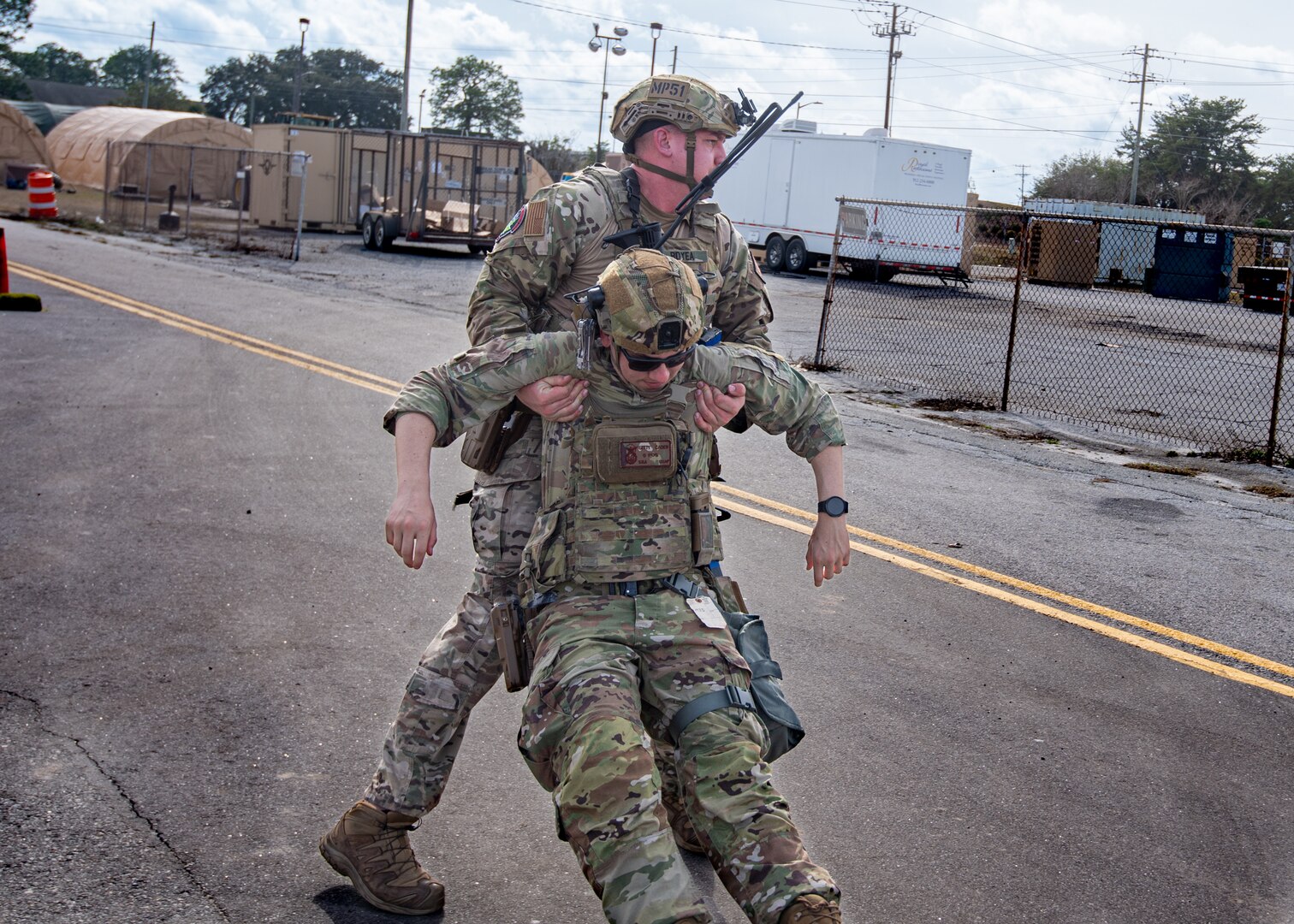 Photo of U.S. Air Force Airman assigned to the 158th Fighter Wing, Vermont Air National Guard, recovering a casualty during a simulated attack at Georgia Air National Guard Base, Savannah, Ga., Jan. 24, 2024.