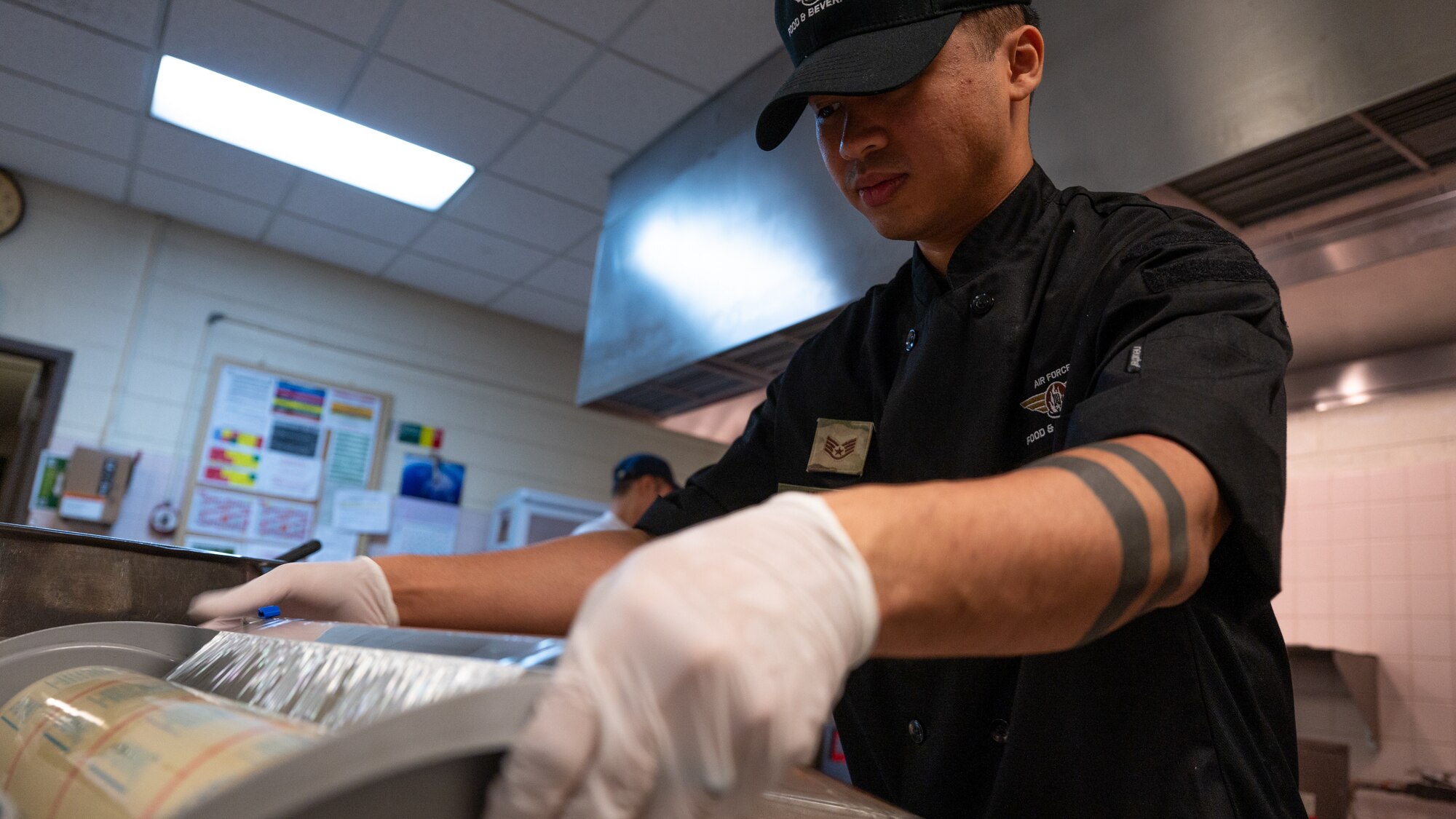 Staff Sgt. Huy Huynh wraps food for lunch service.