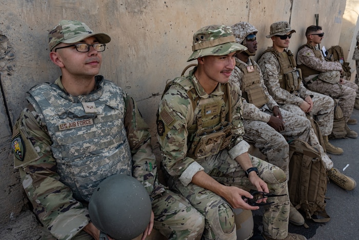 U.S. service members sit and rest together between training exercises.