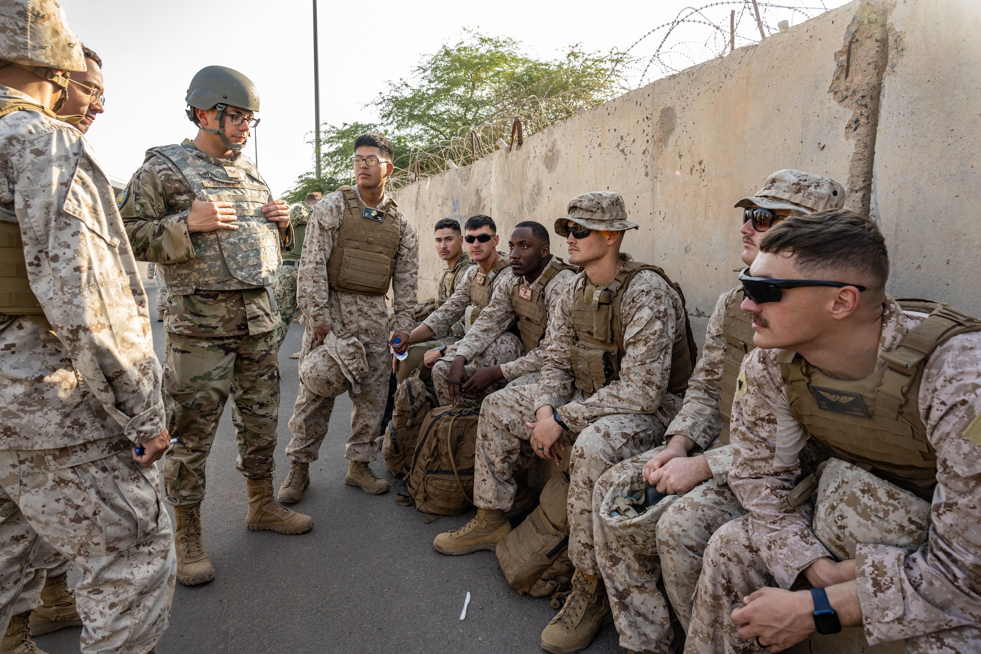 U.S. service members sit together and discuss strategy.