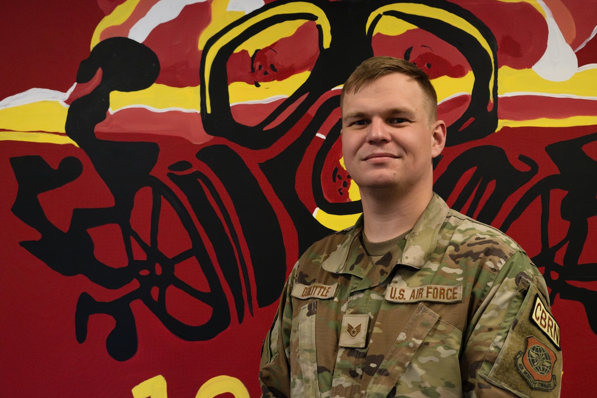 U.S. Air National Guard Staff Sgt. Sam Doolittle, emergency manager with the 105th Airlift Wing’s Civil Engineer Squadron, poses for a portrait in front of a HAZMAT mural at Stewart Air National Guard Base, Newburgh, New York, Feb. 3, 2024. Doolittle was selected as the Air National Guard Noncommissioned Officer Emergency Manager of the Year after competing with Airmen from across the nation.