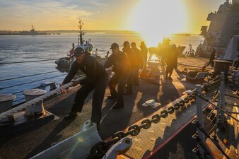 Sailors heave around mooring line aboard USS Bulkeley (DDG 84) at Naval Station Rota, Spain.
