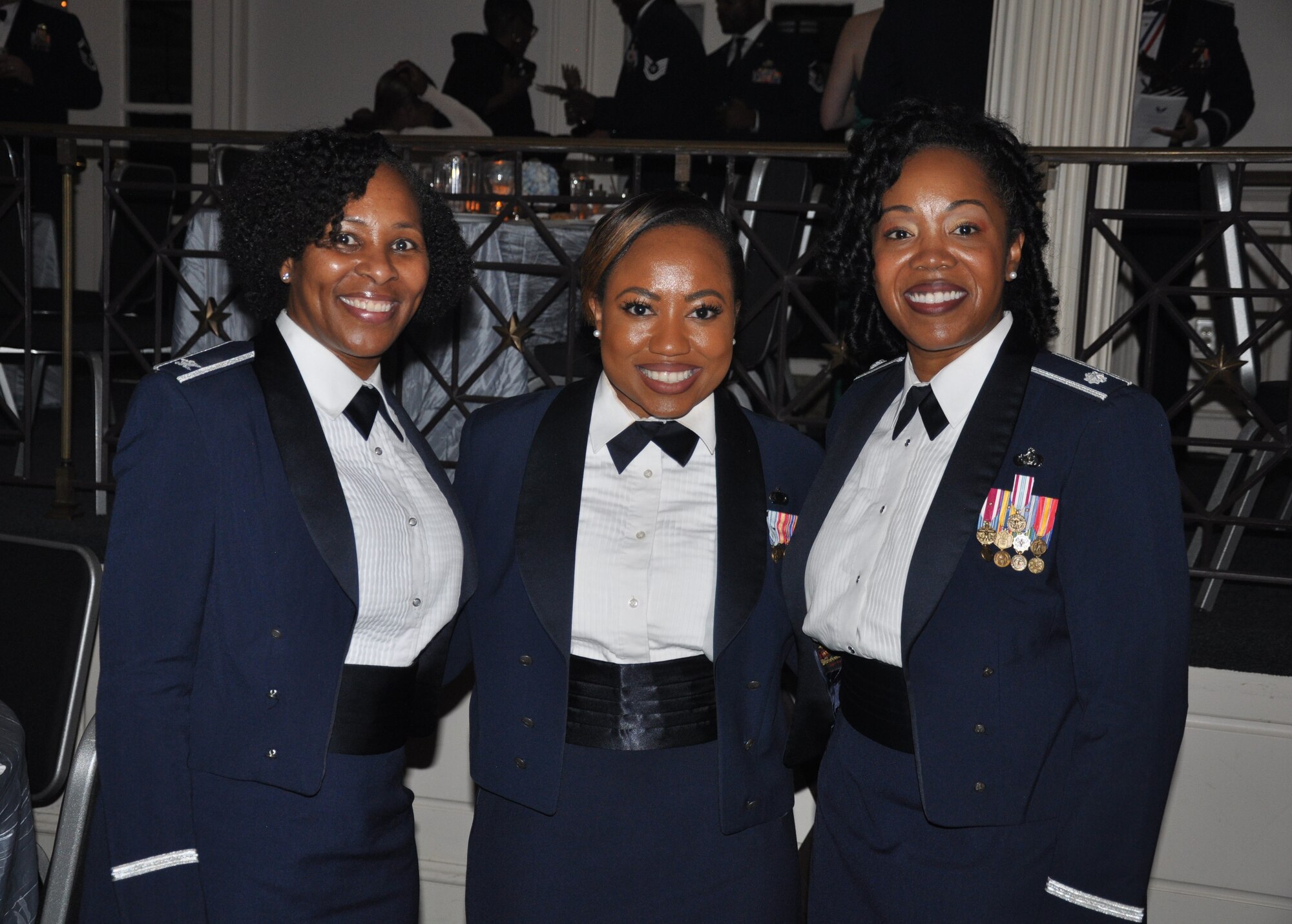 three people pose for a photo