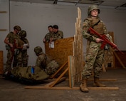 U.S. Air Force 1st Lt. Molly Mathews, 5th Operations Medical Readiness Squadron officer, defends a simulated injured Airman being treated by Tactical Combat Casualty Care (TCCC) at Minot Air Force Base, North Dakota, Jan. 19, 2024. TCCC guidelines are a set of evidence-based, best practice guidelines for battlefield trauma care, developed over more than 18 years. (U.S. Air Force photo by Senior Airman Alexander Nottingham)