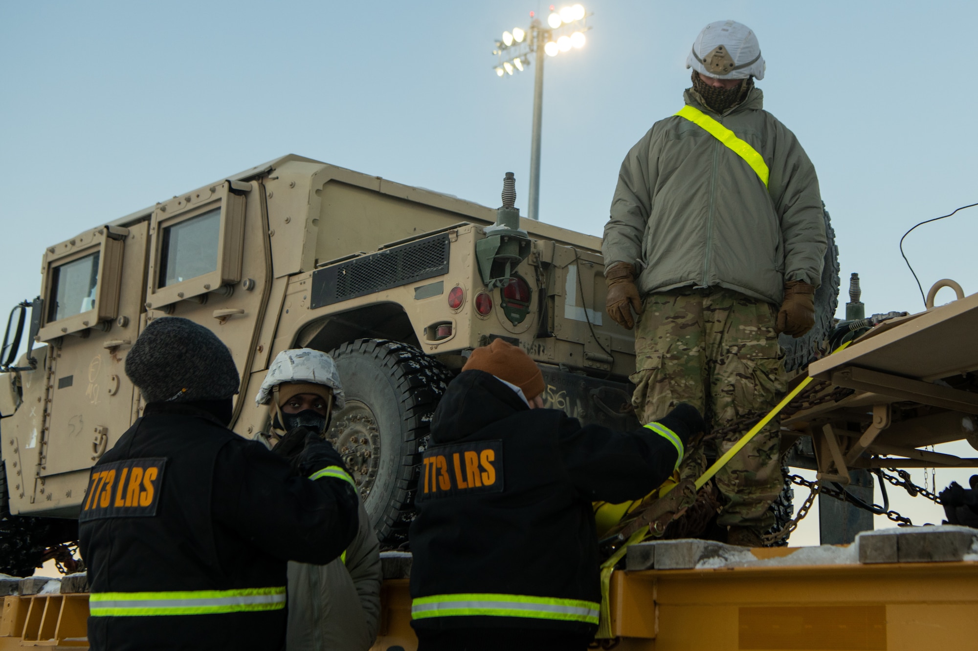 U.S. Army Soldiers assigned to the 17th Combat Support Sustainment Battalion and members of the U.S. Air Force's 773rd Logistics Readiness Squadron load vehicles onto rail lines at Joint Base Elmendorf Richardson, Alaska, Jan. 22, 2024, ahead of Joint Pacific Multinational Readiness Center 24-2.