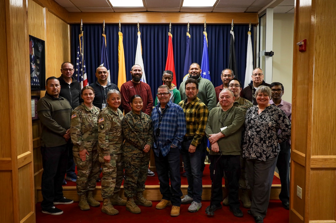 El Paso Military Entrance Processing Station (MEPS) take a group photo in the ceremonial room at El Paso TX, on Dec. 18, 2023. El Paso MEPS has set an example of efficiency, communication, and dedication in military enlistment (U.S. Marine Corps photo by Cpl. Mark Morales).