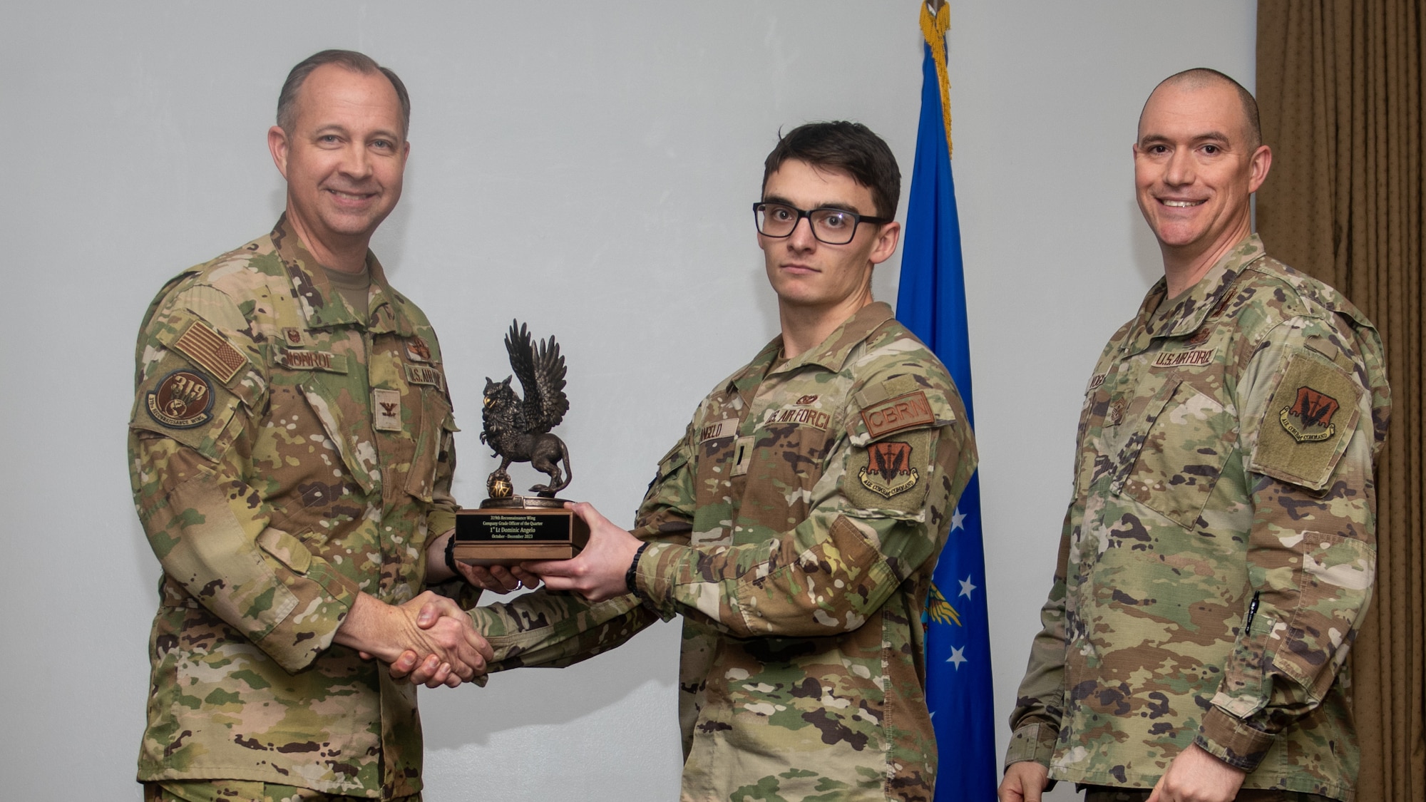 A man in a military uniform receives an award.