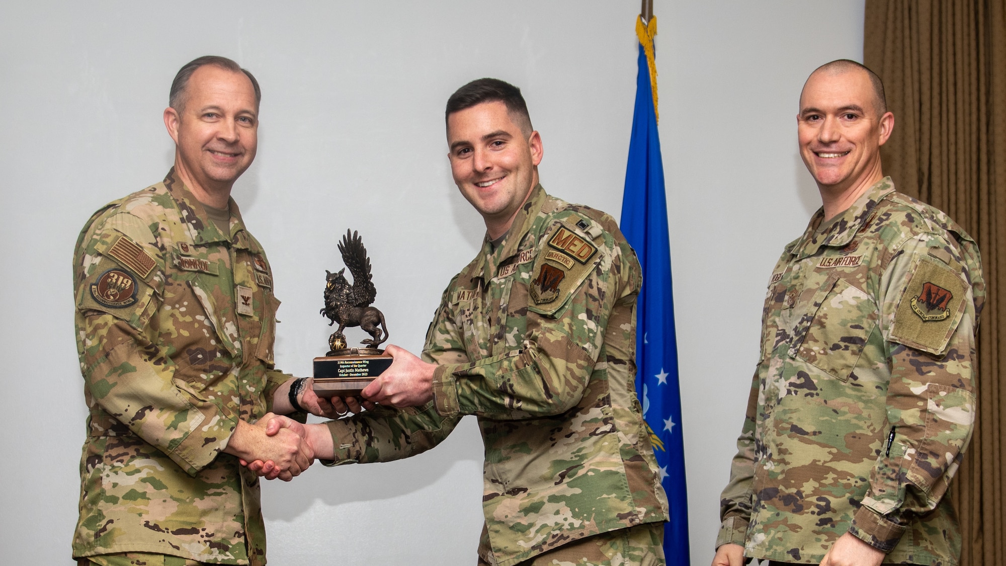 A man in a military uniform receives an award.