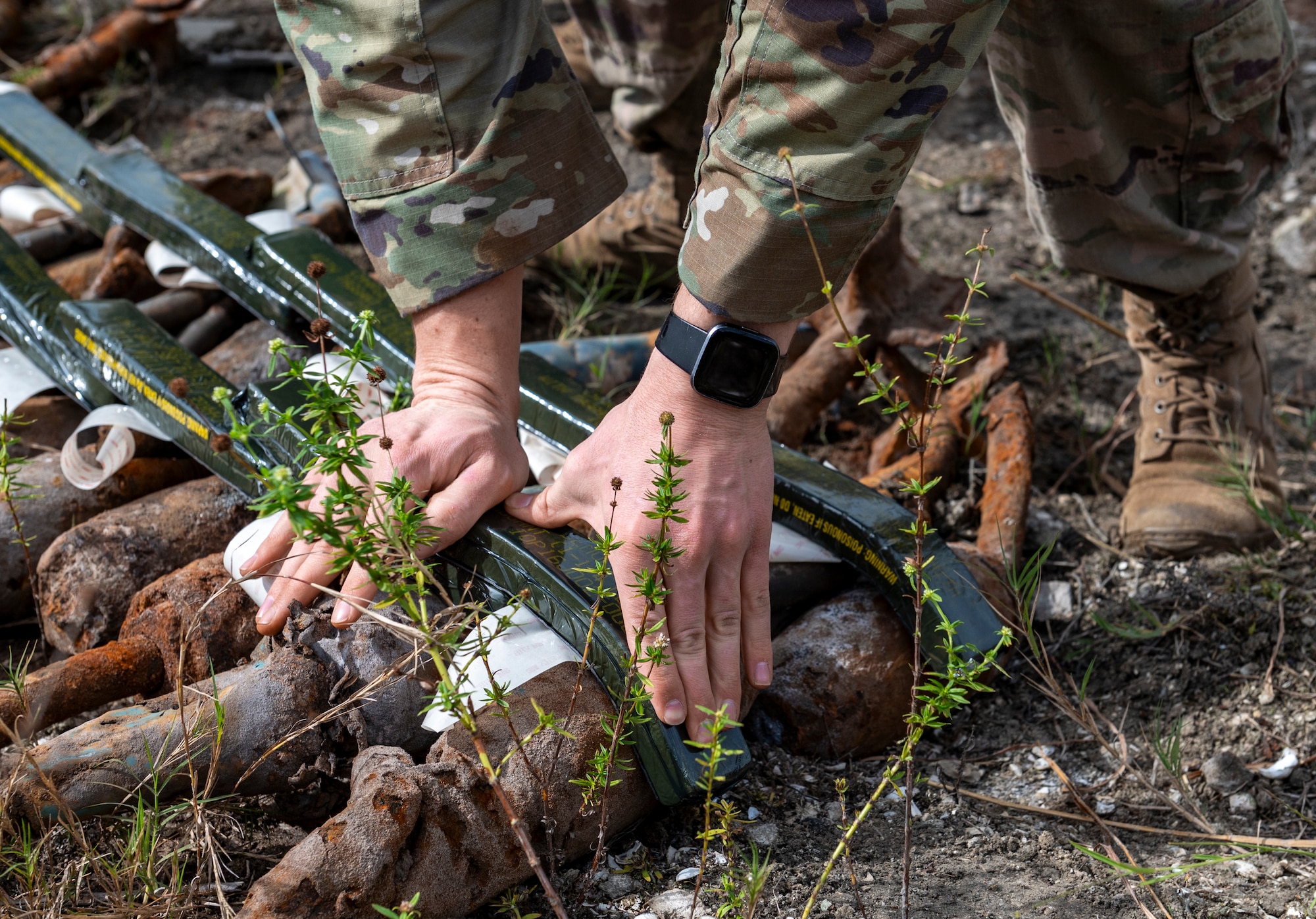 A U.S. Air Force Airman assigned to the 23rd Civil Engineer Squadron Explosive Ordnance Disposal unit places plastic explosives on used munitions at Avon Park Air Force Range, Florida, Jan. 24, 2024. The EOD Airmen are trained to safely handle explosives to successfully dispose of potential hazards on airfields and military installations. (U.S. Air Force photo by Airman 1st Class Leonid Soubbotine)