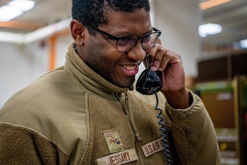 An Airmen makes the final call from an analog phone supported by the Meridian Stored Logic 100 switch.