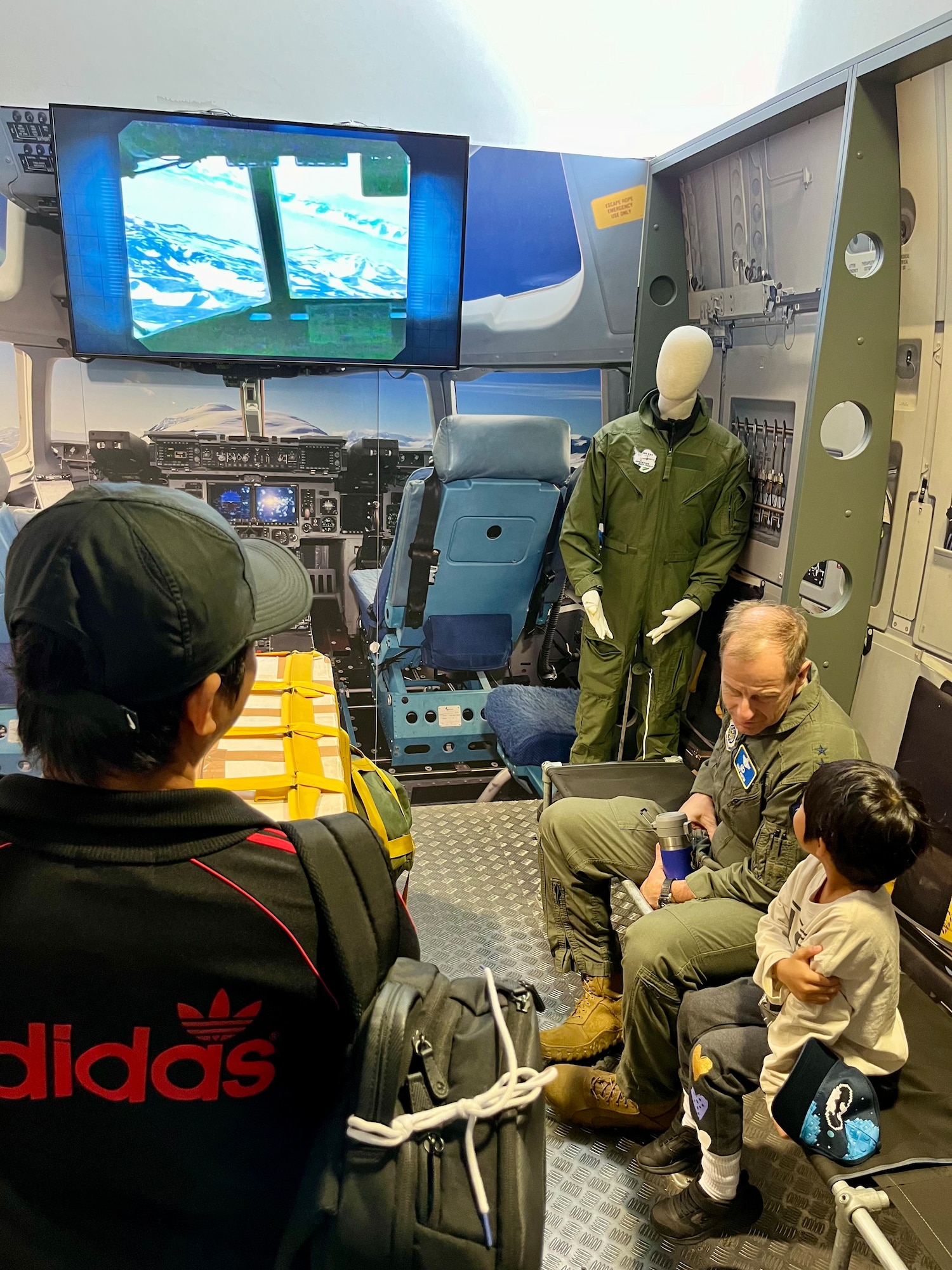 Maj. Gen. Corey Martin, 18th Air Force commander, entertains a lively child from the Philippines who recently moved to New Zealand during Operation Deep Freeze (ODF). ODF is crucial in building relationships with partner nations like New Zealand as well as providing Department of Defense logistical support to the National Science Foundation (NSF) for their continued research with the U.S. Antarctic Program.