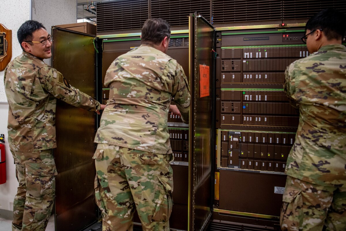 Airmen power down an old telephone switch.