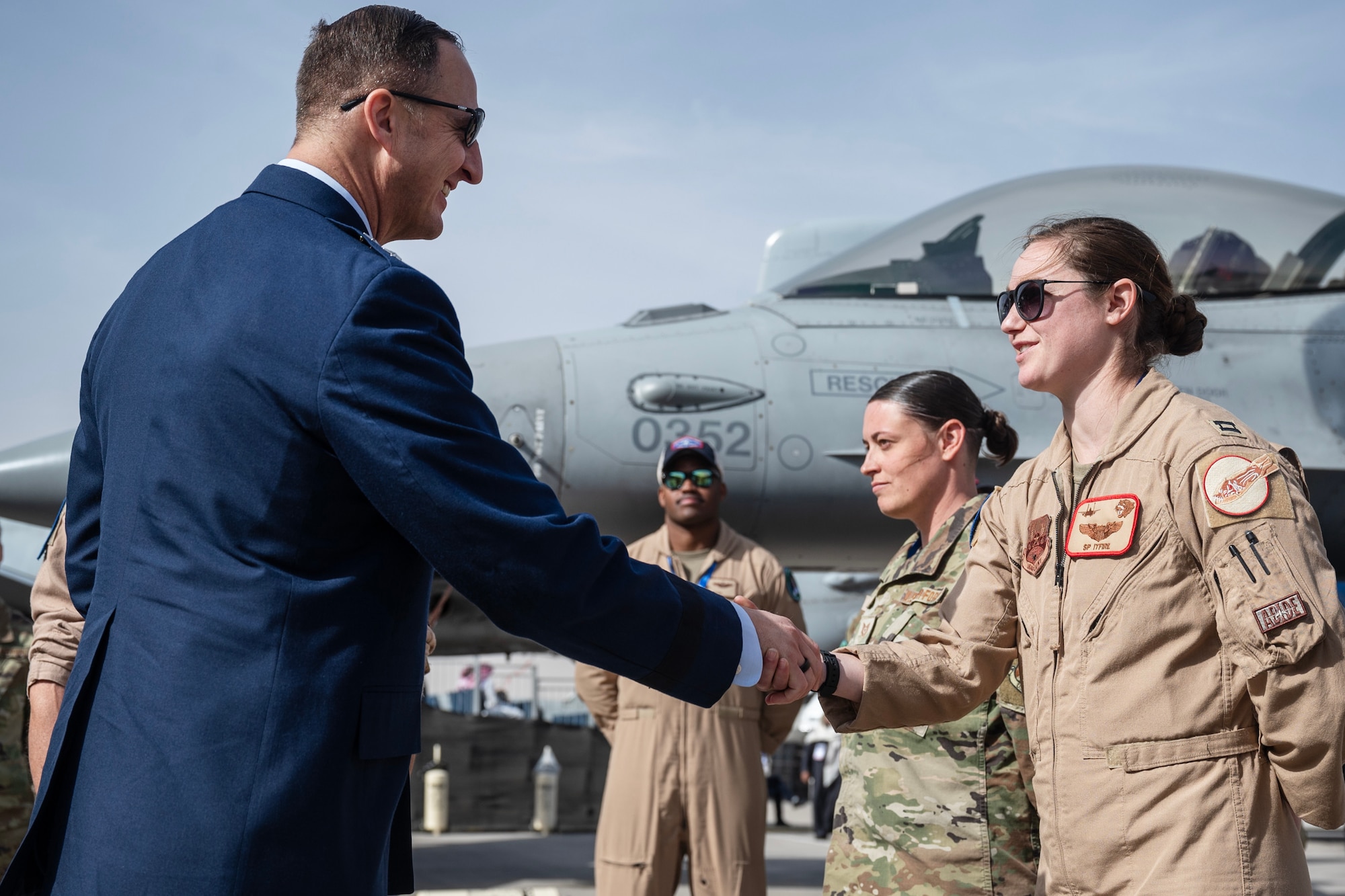 Two people shake hands.
