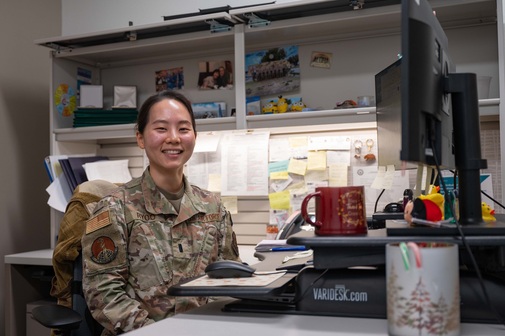 1st Lt. Ryoo poses for a photo at her desk.