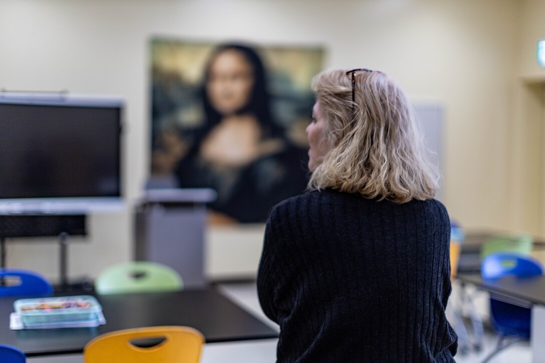 Nicole Colburn, a Department of Defense Education Activity (DoDEA) art teacher at Iwakuni Intermediate School, looks around her classroom at Marine Corps Air Station Iwakuni, Japan, Jan. 12, 2024. A native of Shirley, Massachusetts, Colburn teaches art as a way to follow her passion for the history, culture, and creativity of art.(U.S. Marine Corps Photo by Cpl. Peter Rawlins)