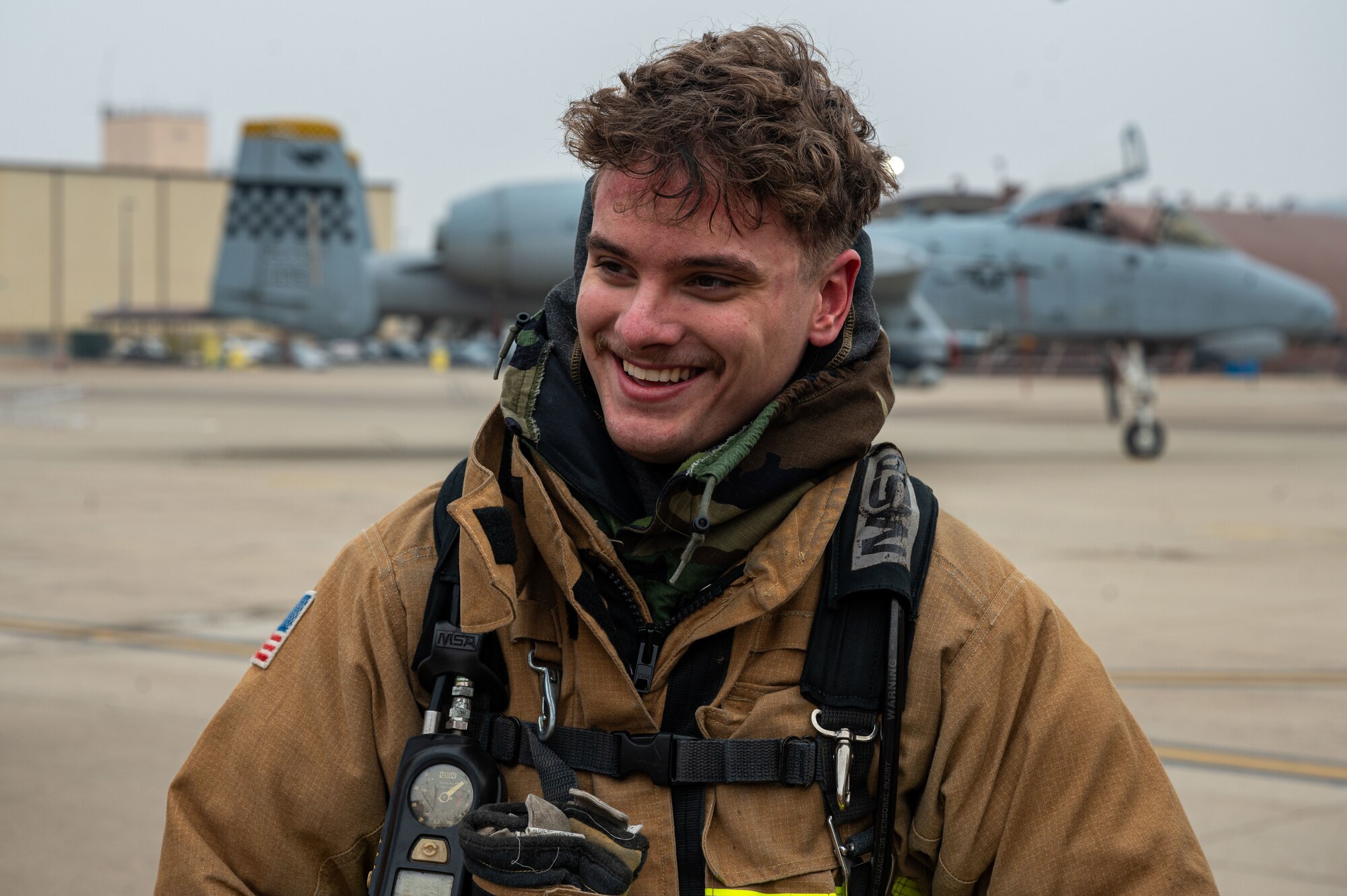 U.S. Air Force Airman 1st Class Tanner Hanson, 51st Civil Engineer Squadron firefighter, converses with a wing inspection team member following a simulated flight line emergency at Osan Air Base, Republic of Korea, Feb. 1, 2024. Firefighters from the 51st CES continuously train in order to maintain the level of readiness needed to ensure safety for base personnel. (U.S. Air Force photo by Airman 1st Class Chase Verzaal)