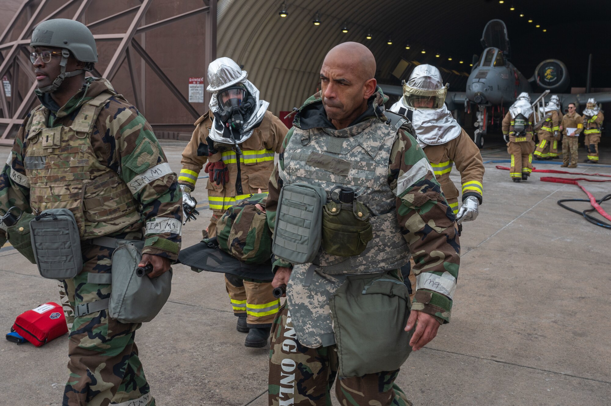 U.S. Air Force firefighters from the 51st Civil Engineer Squadron and augmented personnel carry a stretcher during a simulated flight line emergency at Osan Air Base, Republic of Korea, Feb. 1, 2024. Firefighters from the 51st CES continuously train in order to maintain the level of readiness needed to ensure safety for base personnel. (U.S. Air Force photo by Airman 1st Class Chase Verzaal)