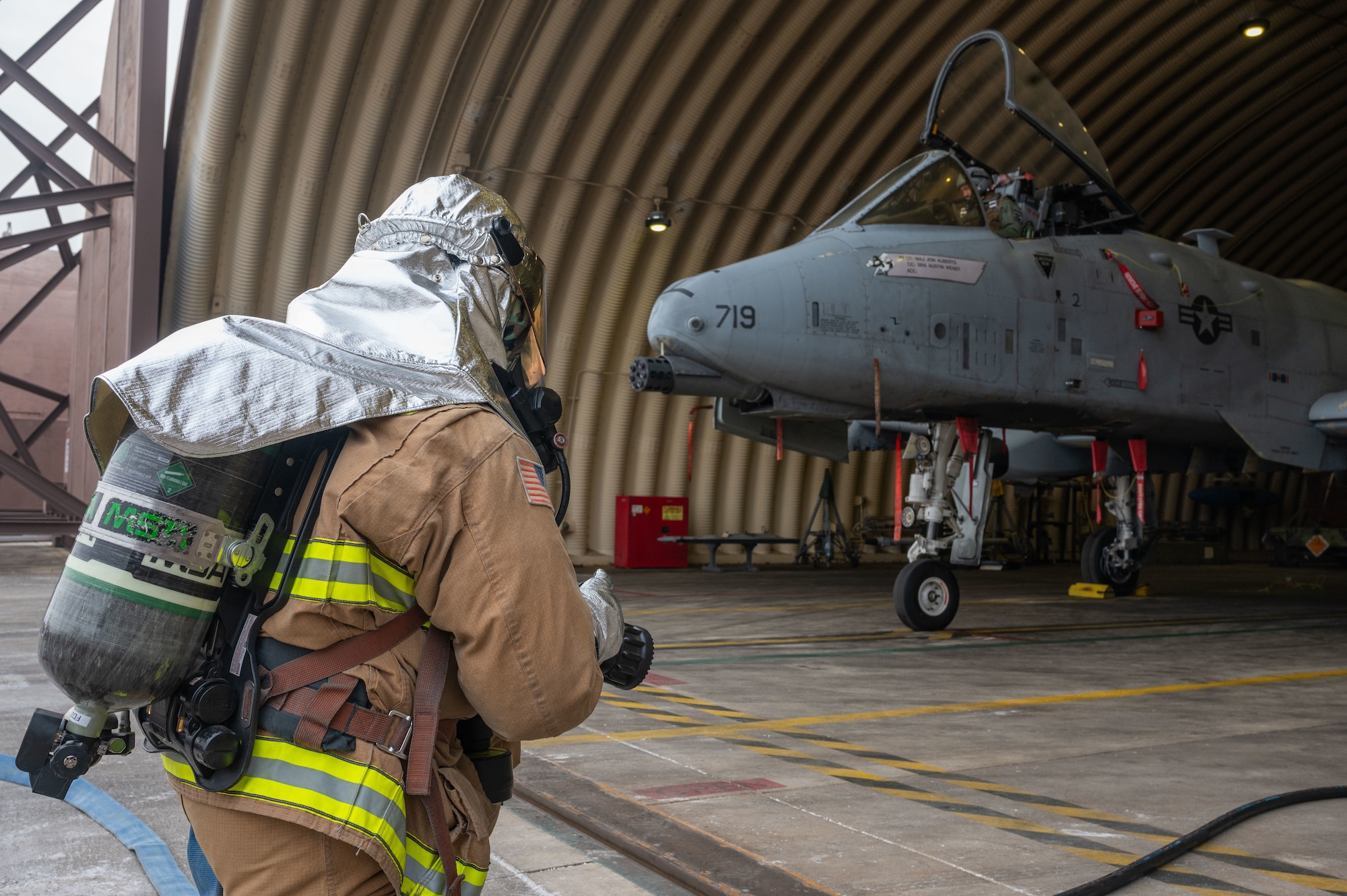 U.S. Air Force Senior Airman Derek Hinton, 51st Civil Engineer Squadron driver/operator, simulates extinguishing flames at a flight line emergency at Osan Air Base, Republic of Korea, Feb. 1, 2024. Firefighters at Osan participate in regular training and are thoroughly evaluated to ensure that they will be prepared in the event of a real-world threat. (U.S. Air Force photo by Airman 1st Class Chase Verzaal)