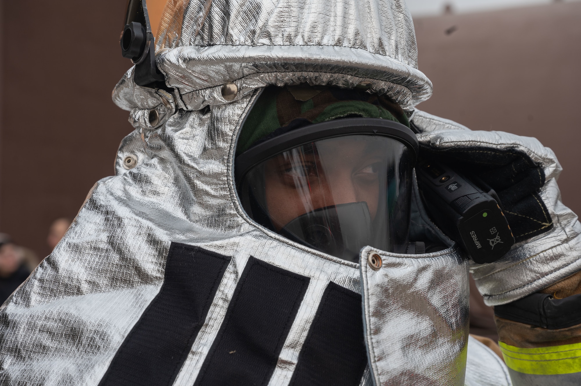 U.S. Air Force Senior Airman Tahji Pinkney, 51st Civil Engineer Squadron firefighter, communicates via radio during a simulated flight line emergency at Osan Air Base, Republic of Korea, Feb. 1, 2024. Firefighters have to be quick and decisive when responding to emergencies, and being multi-capable Airmen allows them to remain in control of threats. (U.S. Air Force photo by Airman 1st Class Chase Verzaal)
