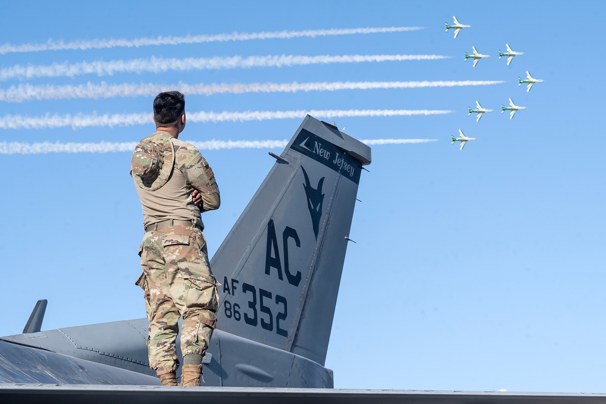 Man observes aircraft in flight.