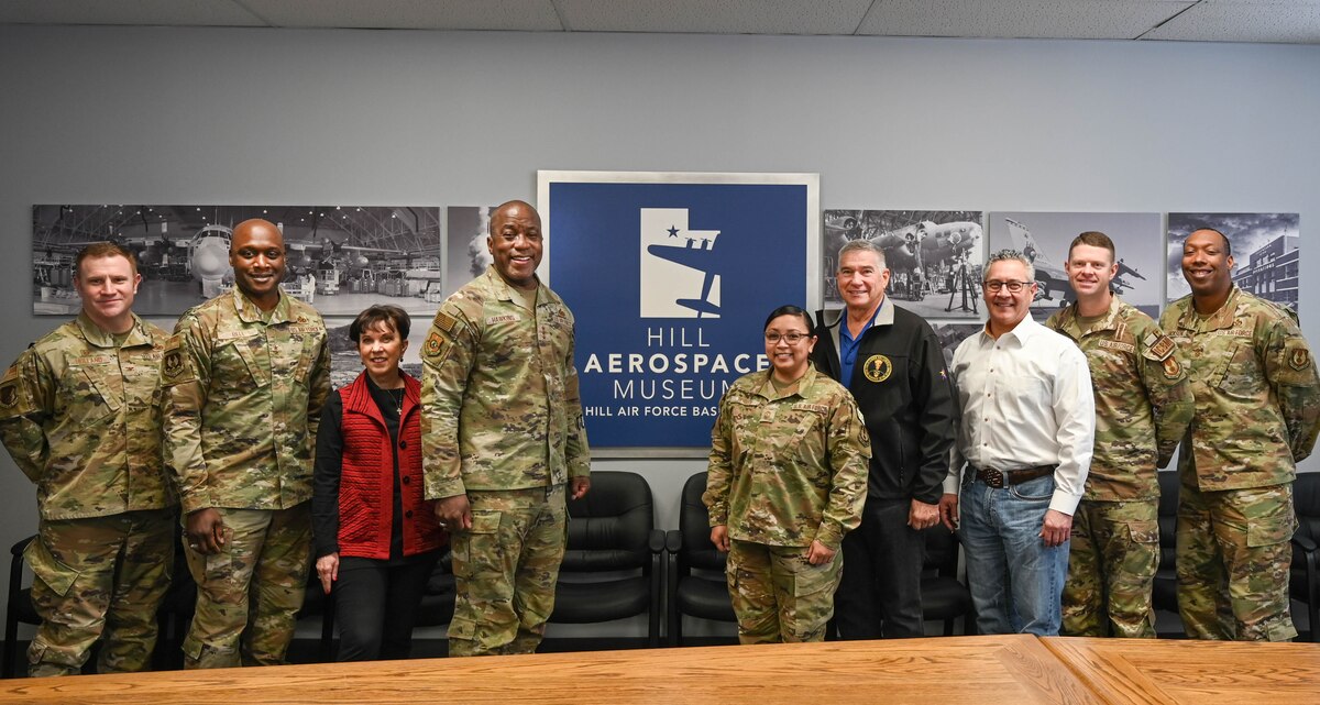 A group of people standing in front of the Aerospace Museum sign