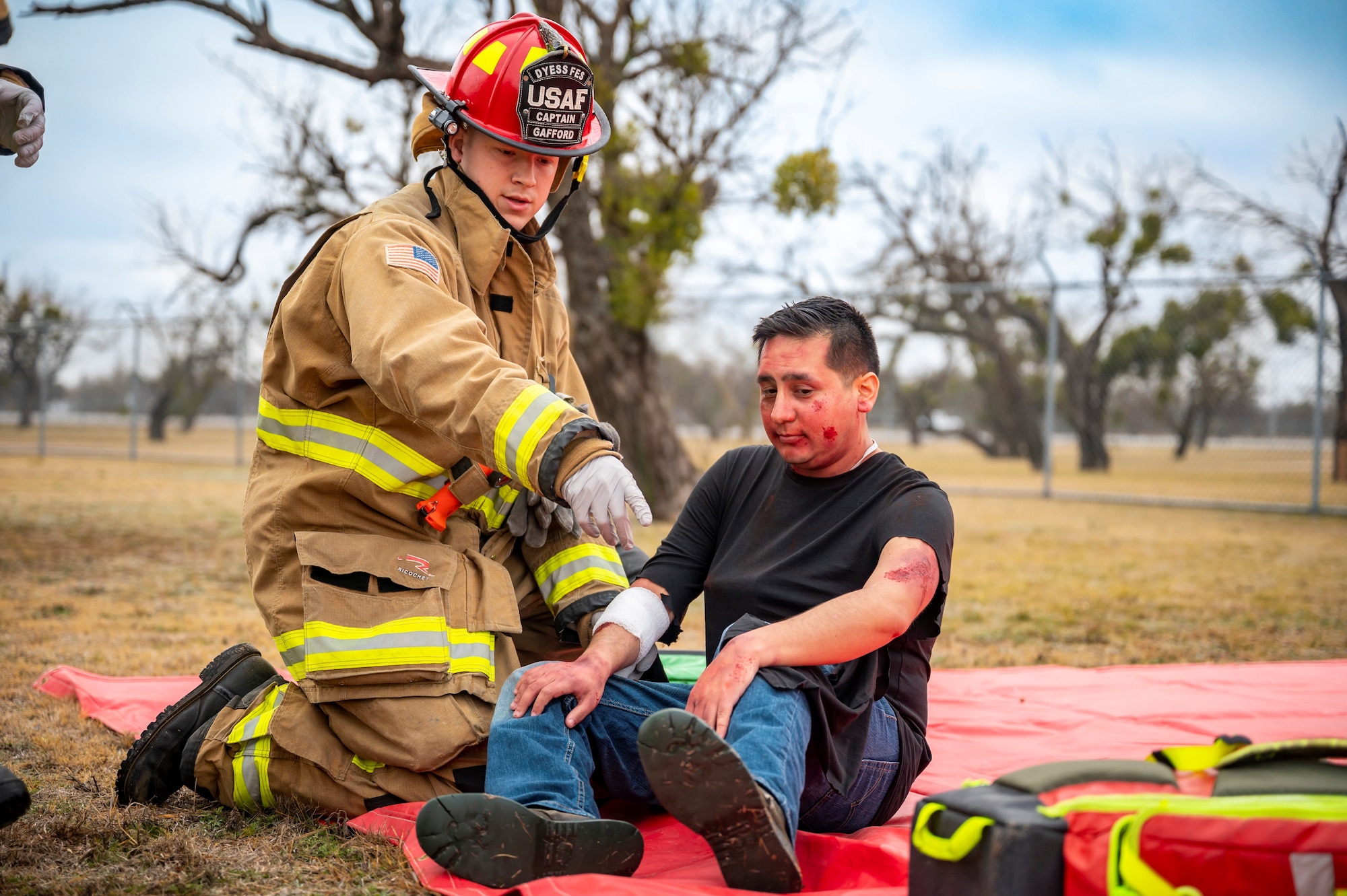 A 7th Civil Engineer Squadron firefighter assists a simulated medical patient during the Ready Eagle II exercise capstone at Dyess Air Force Base, Texas, Jan. 25, 2024. Ready Eagle II is an Air Force-wide directed training held to increase medical readiness for home station response to any medical emergencies or hazardous incidents. (U.S. Air Force photo by Senior Airman Leon Redfern)