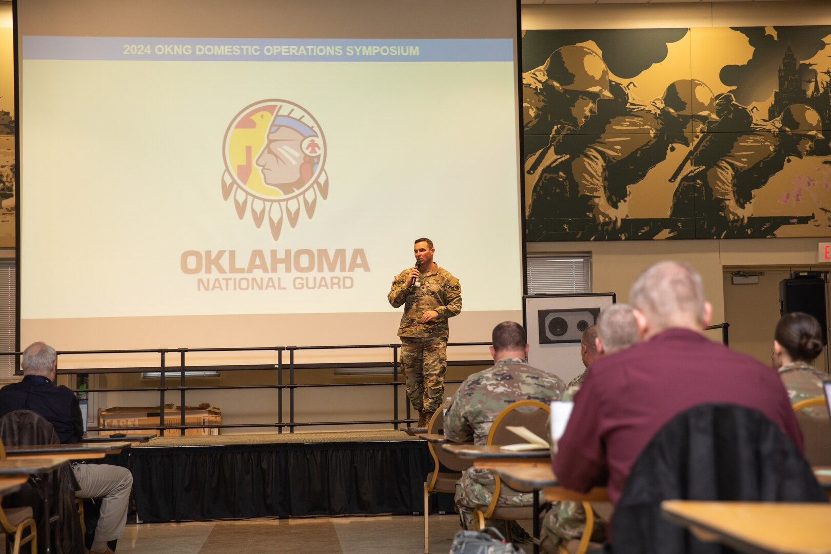Lt. Col. Brent Hill, deputy director of military support for the Oklahoma National Guard, speaks at the inaugural Domestic Operations Symposium at the Armed Forces Reserve Center in Norman, Oklahoma, Jan. 23, 2024. More than 20 emergency response agencies from across the state gathered for the event to build a shared understanding of roles and responsibilities, encourage collaborative planning, mutual aid, and participation in upcoming training events. (Oklahoma National Guard photo by Staff Sgt. Reece Heck)